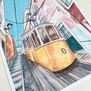 May include: Watercolor painting of a yellow tram traveling up a steep, cobblestone street in a city. The tram is traveling up a set of stairs with buildings on either side of the street.