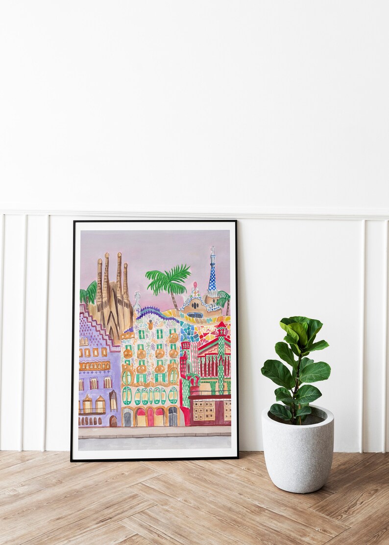May include: A framed watercolor painting of colorful buildings with a pink sky in the background. The buildings are in a style reminiscent of Antoni Gaud&iacute;'s architecture.