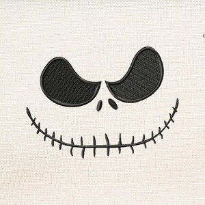 May include: Black and white embroidered design of a stitched-up mouth and two eyes, resembling the character Jack Skellington from the movie "The Nightmare Before Christmas".