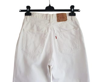 May include: White denim shorts with a red Levi's tab on the back pocket.