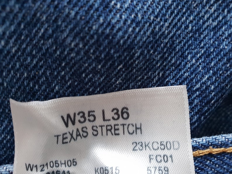 May include: A white tag with black text that reads "W35 L36 TEXAS STRETCH 23KC500 FCD1 W12105H05".