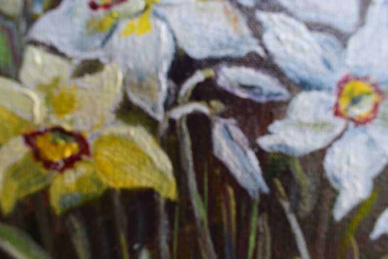 May include: A close-up of a painting of white and yellow flowers with green stems. The flowers are in focus, while the background is blurred.