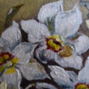May include: A close-up of a painting of white flowers with yellow and red centers. The flowers are painted in a realistic style and have a soft, delicate appearance.