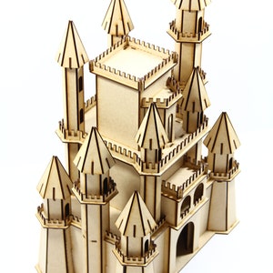 May include: A wooden model of a castle with multiple towers and a detailed facade. The castle is made of light brown wood and has a whimsical design.