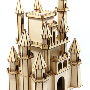 May include: A wooden model of a castle with multiple towers and a large central structure. The castle is made of light brown wood and has intricate details, including windows, doors, and a drawbridge.
