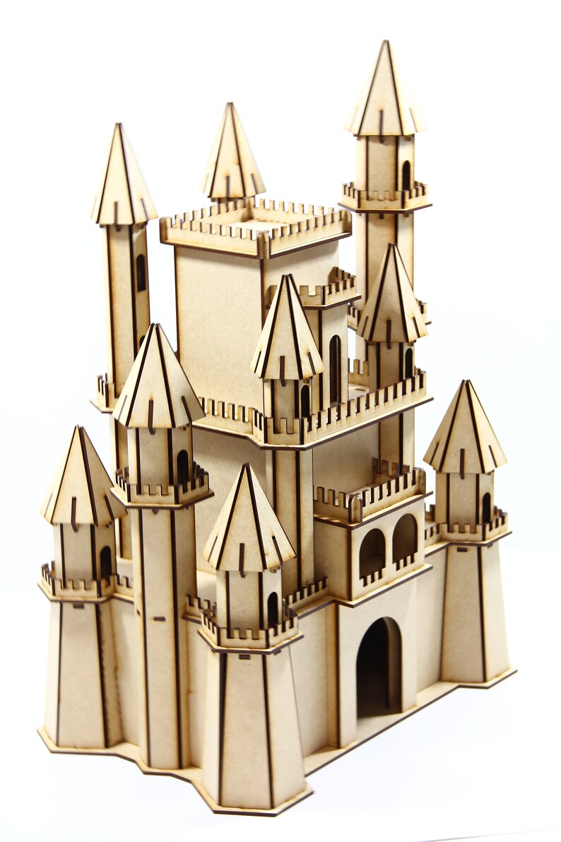 May include: A wooden model of a castle with multiple towers and a large central structure. The castle is made of light brown wood and has intricate details, including windows, doors, and a drawbridge.