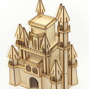 May include: A wooden model of a castle with multiple towers and a large central tower. The castle is made of light brown wood and has intricate details, including windows, doors, and a drawbridge.