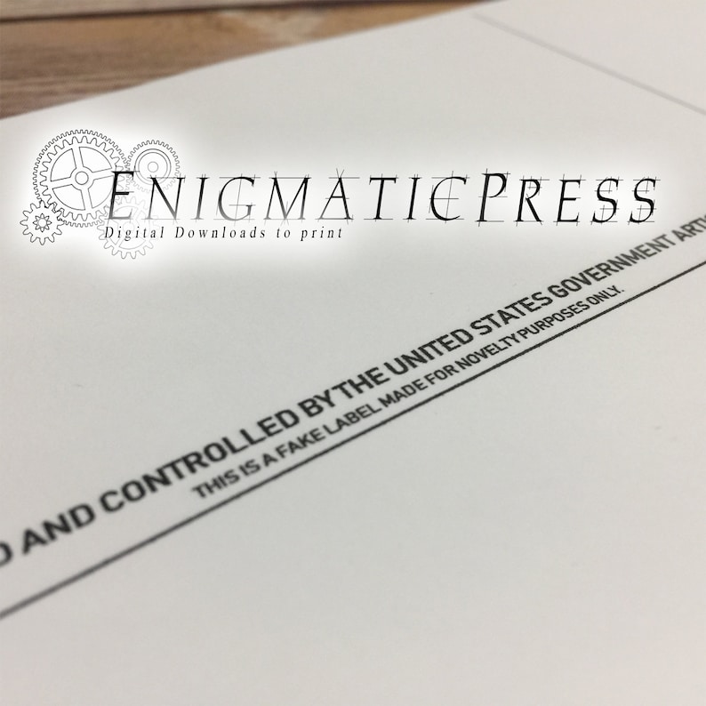 May include: A white paper with black text that reads "THIS IS A FAKE LABEL MADE FOR NOVELTY PURPOSES ONLY. AND CONTROLLED BY THE UNITED STATES GOVERNMENT ART" and the text "Digital Downloads to print ENIGMATIEPRESS".