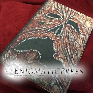 Może przedstawiać: Brązowa i czarna okładka dziennika o fakturowanej, spękanej i postarzanej fakturze. Okładka przedstawia dużą, zdeformowaną twarz z szeroko otwartą paszczą. Tekst "ENIGMATIC PRESS" jest nadrukowany na biało u dołu okładki. Cyfrowe pliki do wydruku.