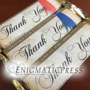 May include: Three chocolate bar wrappers with a vintage design. The wrappers are brown with gold accents and feature the text "Thank You" in a decorative script font. The wrappers also include the text "Thanks for everything Sean!" and "Great Job Chris!"