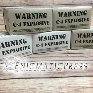 May include: Four brown cardboard boxes with black warning labels that read "WARNING C-4 EXPLOSIVE". The boxes are stacked on top of each other. The text on the boxes reads: "CAUTION: THIS EXPLOSIVE COMPOUND MAY ONLY BE USED IN THE INTERESTS OF NATIONAL SECURITY OF THE UNITED STATES OF AMERICA. UNAUTHORIZED USE CONSTITUTES A FELONY CHARGE UNDER ARTICLE CODE H-2247."