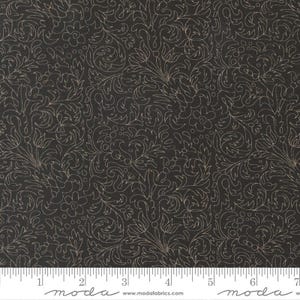 May include: Dark fabric with a repeating floral pattern in a light beige color. The design features swirling vines, leaves, and small flower shapes. The fabric has a ruler along the bottom with the word "moda" printed on it.