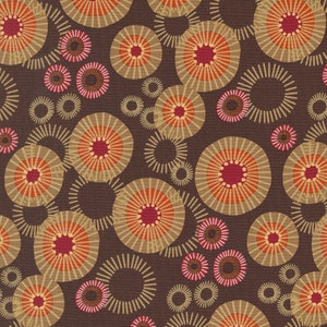 May include: A brown fabric with a repeating pattern of concentric circles in shades of orange, red, and beige. The circles have a sunburst design.