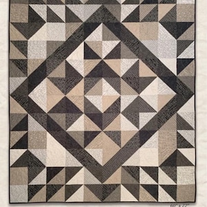 May include: A quilt pattern titled "Hearthside" with a geometric design in shades of gray, tan, and black. The quilt measures 60" x 72" and features a diamond-shaped central pattern. The text reads "Two Layer Cakes is all it takes to create this quilt!" by Kathy Schmitz.