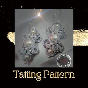 May include: A pair of silver tatting earrings with white pearls. The earrings are in the shape of a flower with a loop at the top for hanging. The earrings are handmade and are a beautiful example of the art of tatting.