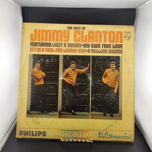 May include: Vintage vinyl record album cover titled "The Best Of Jimmy Clanton." The cover features a photo of Jimmy Clanton in an orange sweater. The album includes the songs "Just a Dream" and "My Own True Love."