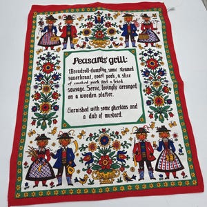 May include: A decorative kitchen towel with a red border and a white center featuring a floral design and figures in traditional clothing. The text reads "Peasant's grill" with a description of a meal.
