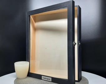 May include: Black wooden shadow box with a glass front and a silver metal plate with the text "The Morning Family" on it.