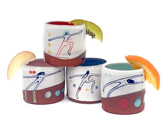Set of handmade wheel-thrown illustrated ceramic cups