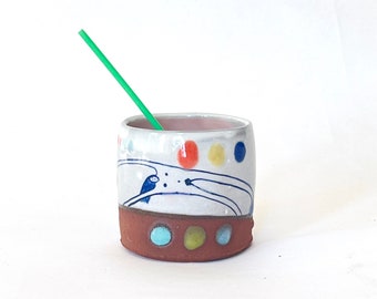 Handmade wheel-thrown illustrated ceramic cup that