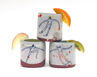Set of handmade wheel-thrown illustrated ceramic cups
