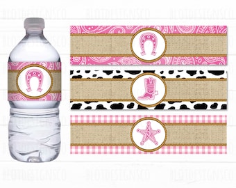 May include: A clear water bottle with a pink horseshoe label. Beside it are three decorative labels with a horseshoe, cowboy boot, and sheriff's star. The labels feature pink paisley, cow print, and gingham patterns with a burlap texture.