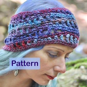 May include: A crocheted headband in shades of blue, purple, and red. The headband is made with a chunky yarn and has a simple, open-stitch pattern. The headband is worn by a person with blue hair.