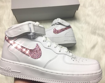 white nike high tops with pink swoosh