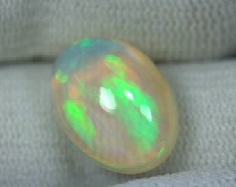 4.94 Carats Magnificient! OPAL Cabochon. 15x11 mm size Oval. Multi color Fire/Flashes. EARTH MINED. Reasonable Price.