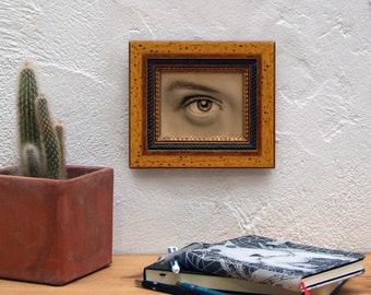 Woman's eye. Acrylic paint oval frame. Original painting on wood framed in golden oval frame.