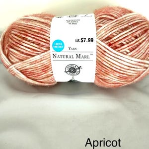 May include: A ball of Natural Marl yarn in apricot color. The label indicates the yarn is 47% polyester, 22% acrylic, and 9% wool. The label also includes the text "Limited Time Only" and the price.
