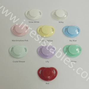 May include: Assortment of ten pacifier clips in various colors, including snow white, milky, marshmallow pink, frosted yellow, sky blue, crystal breeze, lilly, minty, and red.