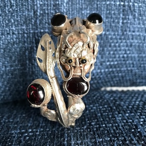 Sterling silver Dragon cuff bracelet, Handmade in Nepal, Dragon holding Garnet stone in his claws and mouth.  wealth/good fortune/heroism
