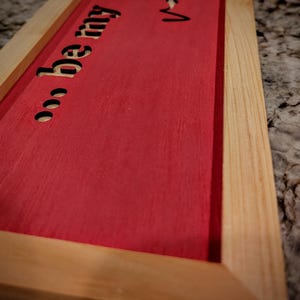 Surrounded by handmade cypress frames the Baltic birch was laser cut leaving the natural wood from behind to show through the words.