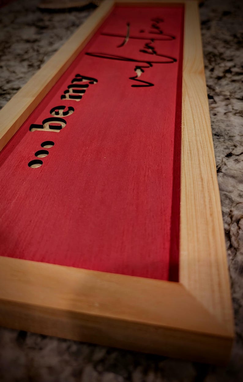 Surrounded by handmade cypress frames the Baltic birch was laser cut leaving the natural wood from behind to show through the words.