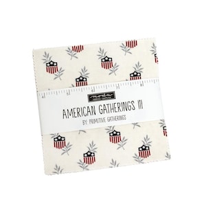 May include: A stack of fabric squares with a repeating pattern of red, white, and blue patriotic shield and leaf designs. The fabric is wrapped with a white label that reads "AMERICAN GATHERINGS III" and "BY: PRIMITIVE GATHERINGS."