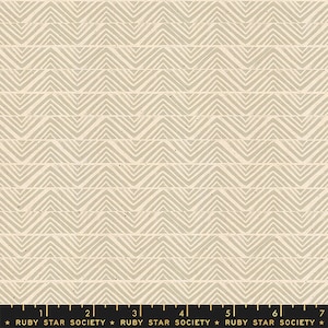 May include: A beige fabric with a white chevron pattern. The fabric has a subtle speckled texture.