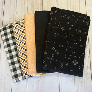 5 yard quilting fabric bundle in Oranges and blacks. 1 yard cut of 5 fabrics great for yard quilt patterns.