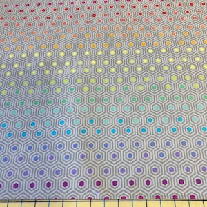 May include: A grey fabric featuring a repeating geometric pattern of hexagons. Each hexagon contains a smaller hexagon in a gradient of colours, ranging from red to purple. Suitable for quilting and crafting projects.