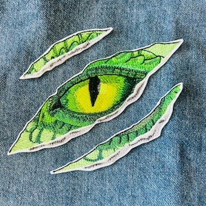 Patch thermocollant brodé oeil de dinosaure de dragon : badge de veste mythique