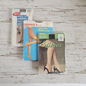 May include: Three packets of tights in various shades and sizes. The packaging includes labels for Secret, Queen Plus, and Silkies. Each individual packet displays a graphic illustration of legs wearing the hosiery products contained within.