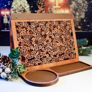 May include: Wooden stand with a decorative butterfly design and two circular trays. The stand is made of light brown wood and has a leather-like top.