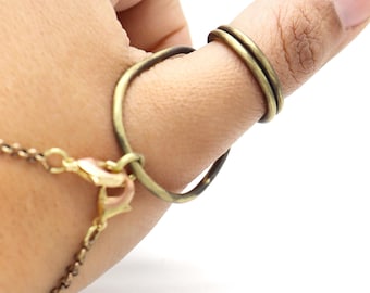 May include: A gold thumb ring with a simple, circular design. The ring is made of metal and has a smooth finish.