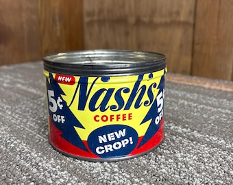 May include: Vintage Nash's Coffee tin with a yellow and blue design. The tin features the text "Nash's Coffee" in a large, stylized font, with "New Crop!" in a blue oval. The tin also has "5¢ OFF" on the sides.