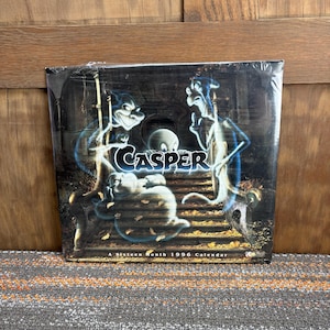 May include: A sixteen-month 1996 calendar featuring Casper the Friendly Ghost and other cartoon ghosts. The cover art is dark with blue and white spectral figures. The word "Casper" is in large, white, stylized letters.