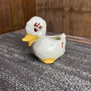 May include: A rustic wooden sign with the text "Welcome to our home" in white lettering. The sign features a distressed finish and a simple, inviting design, perfect for entryway decor.