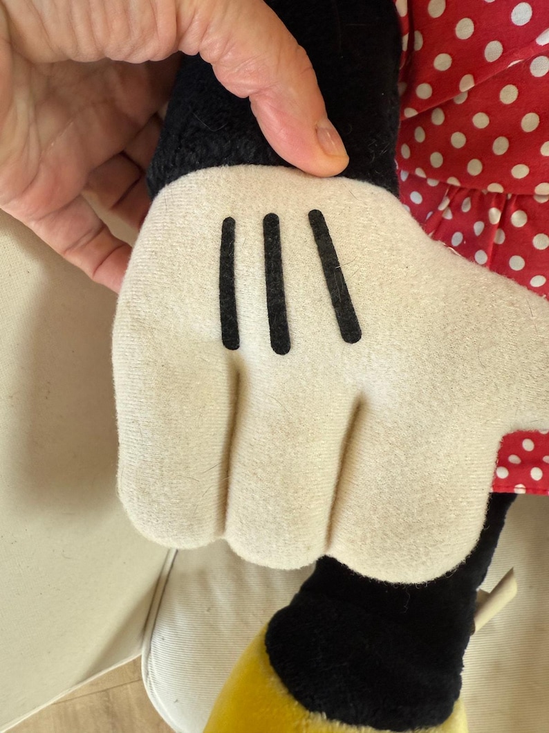 This early 1990s Minnie Mouse plush from Disneyland is a piece of vintage Disney history, blending soft fabric charm with collectible appeal — ideal for display or gifting to a true Disney lover.