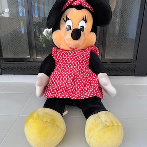 Bring a piece of Disneyland history home with this large vintage Minnie Mouse plush. Her iconic smile and old-style design make her a standout among 90s Disney collectibles.