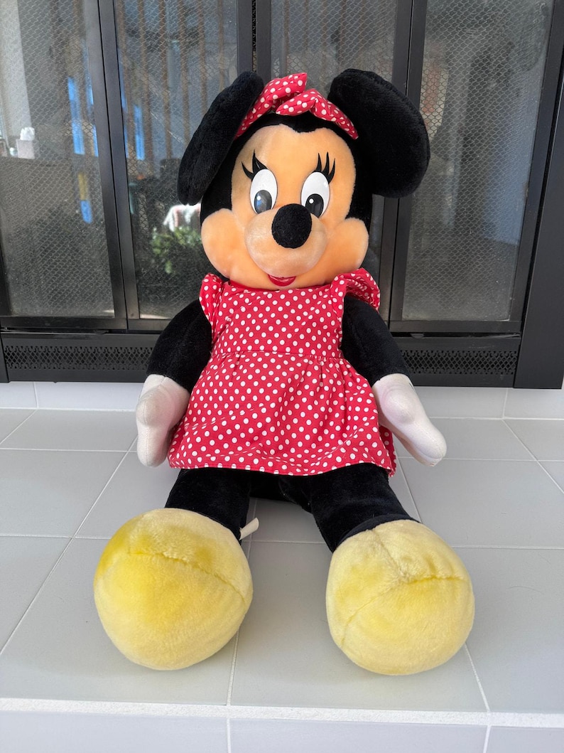 Bring a piece of Disneyland history home with this large vintage Minnie Mouse plush. Her iconic smile and old-style design make her a standout among 90s Disney collectibles.