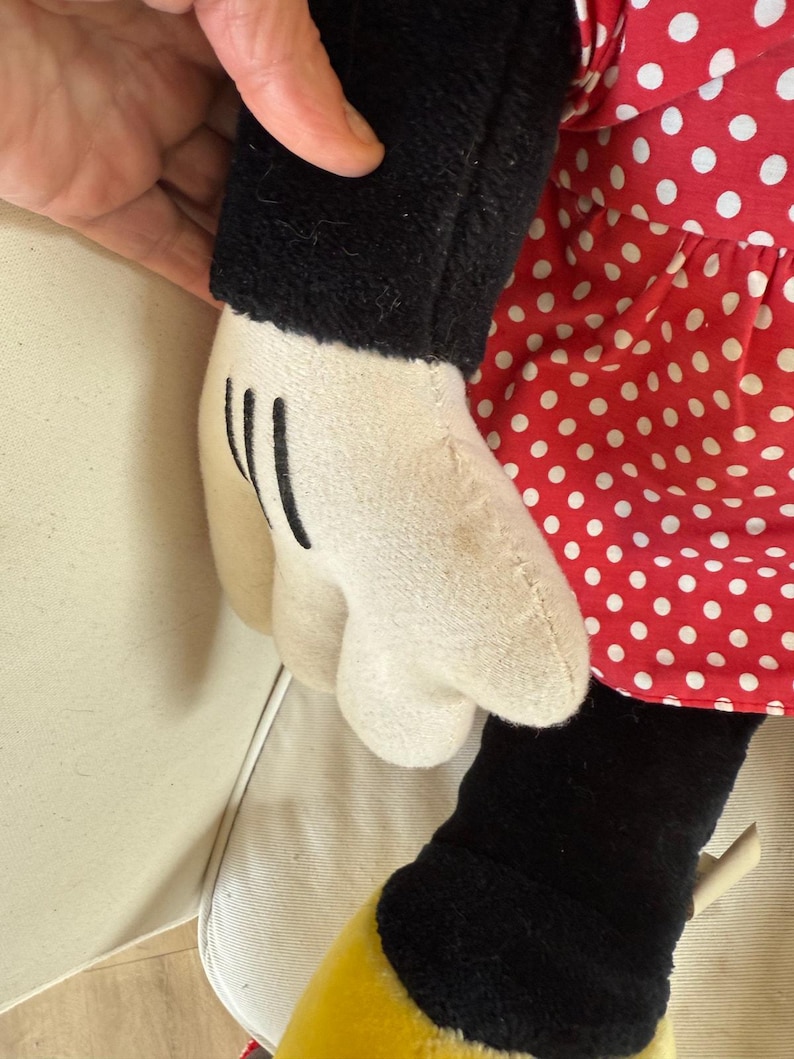 This vintage Disneyland Minnie Mouse plush stands tall at 30 inches, bringing a touch of whimsy and nostalgia to any room or Disney fan collection.